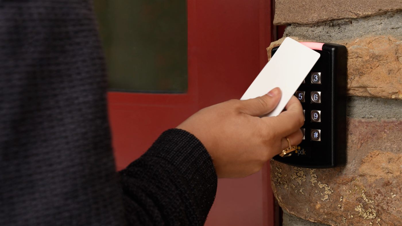 A ProdataKey keypad reader mounted beside a door, being presented with a credential